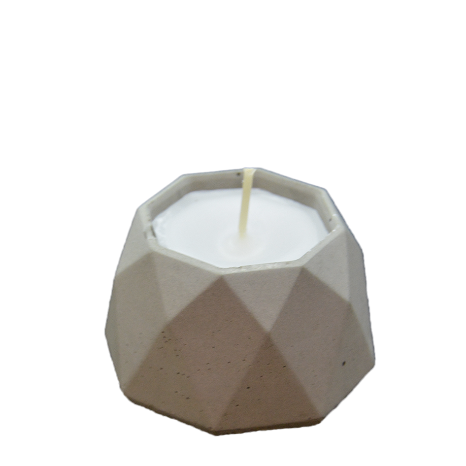 Menší svíčka s vůní kokosu v šedém betonu